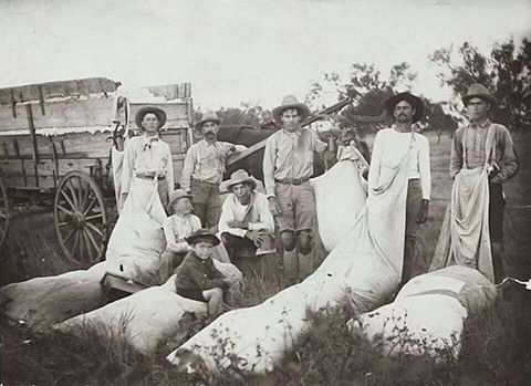 Farming family with freshly picked cotton.